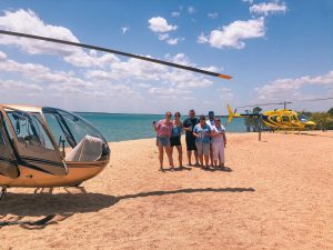 Helicopters landing on the beach at Crab Claw Island Resort